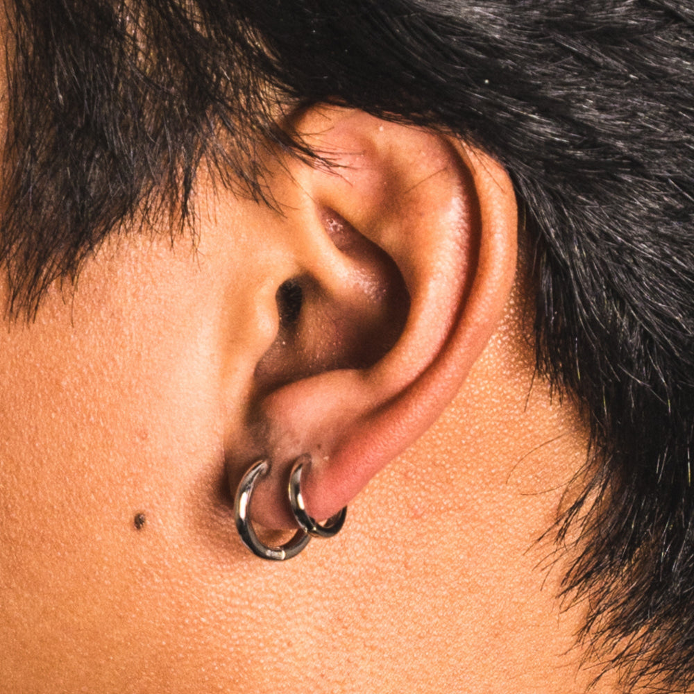 Close-up of an ear with a double hoop earring