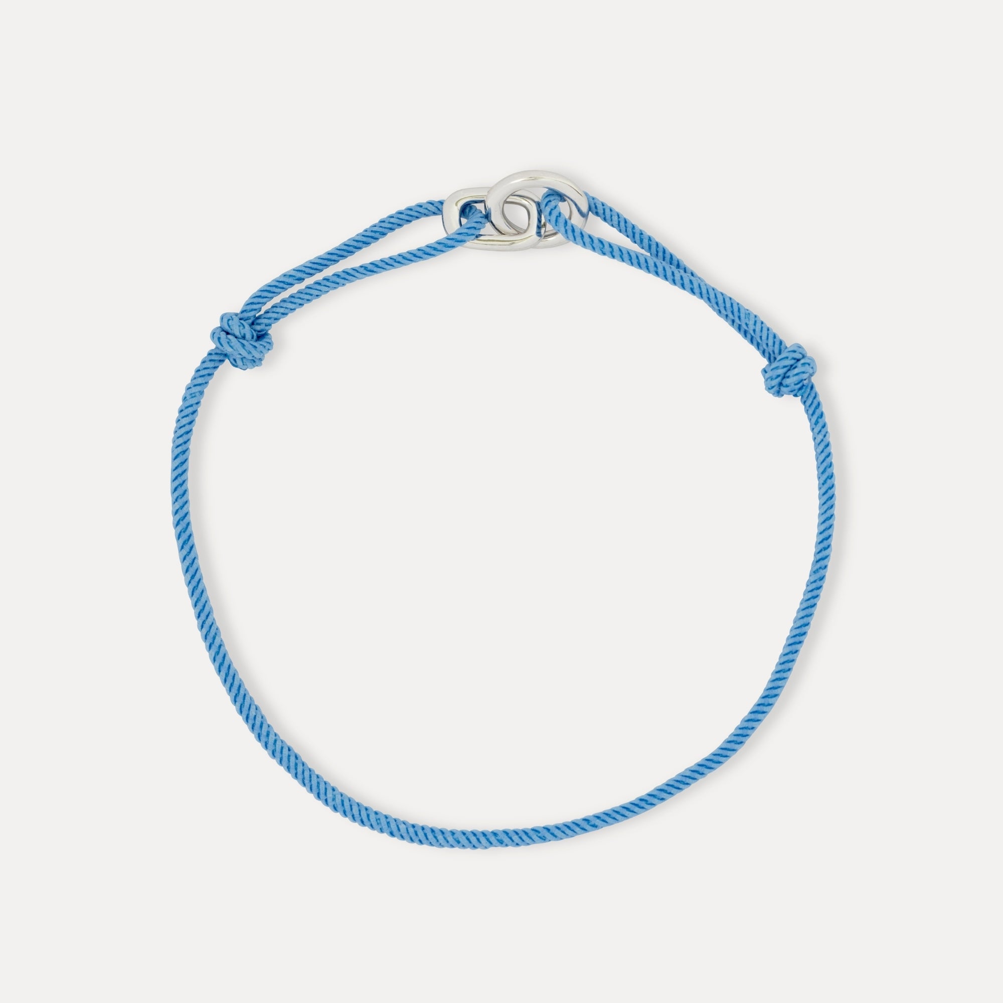 Blue bracelet on a light gray background