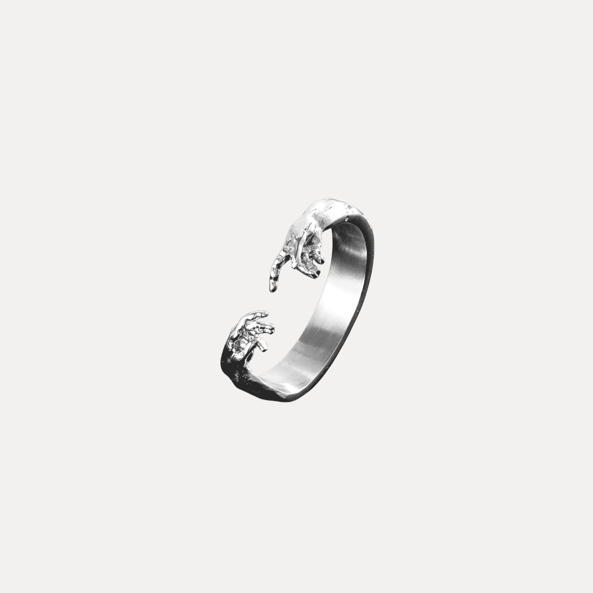 Silver ring with floral design on a light gray background
