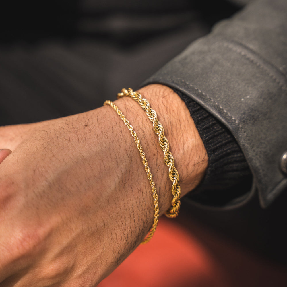 Gold chain bracelet on a wrist with a blurred background