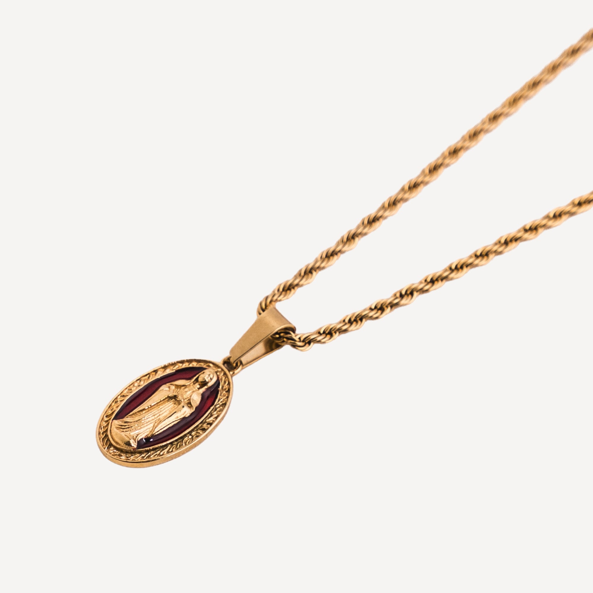 Gold necklace with a pendant on a white background