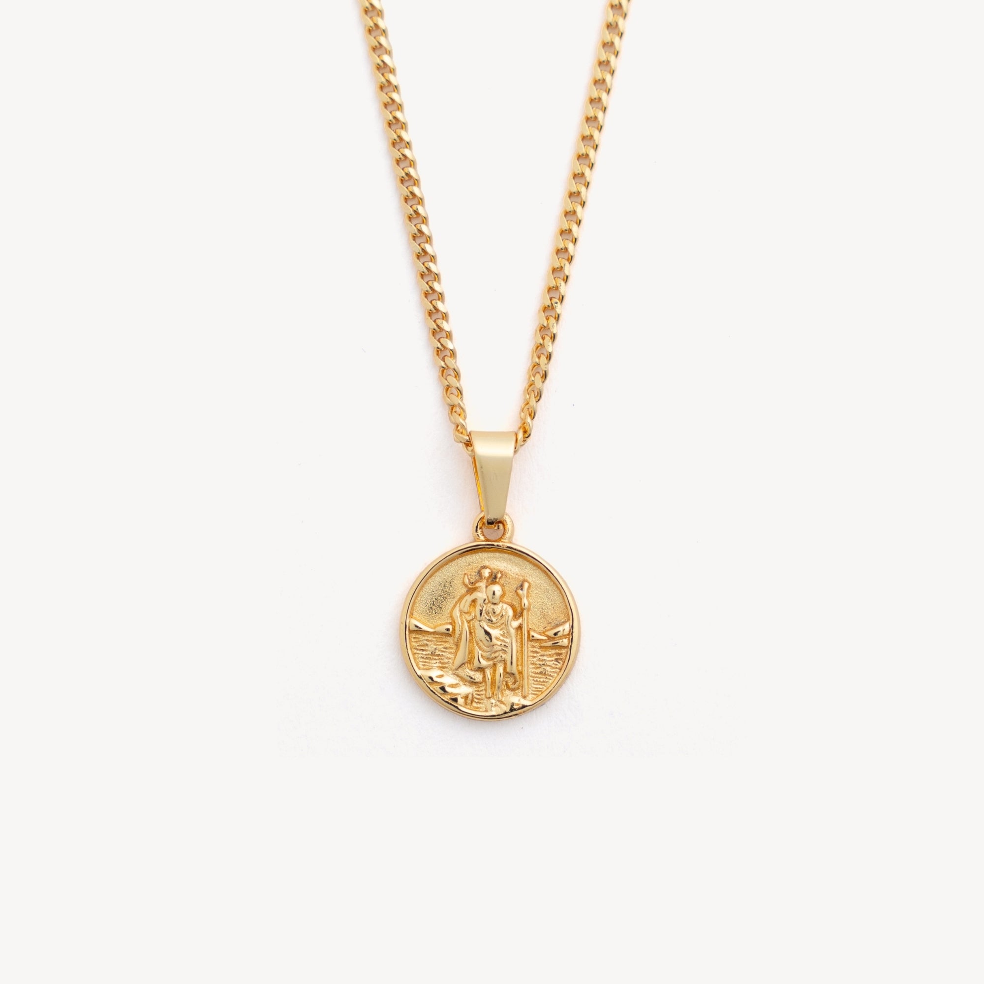 Gold necklace with a round pendant on a white background