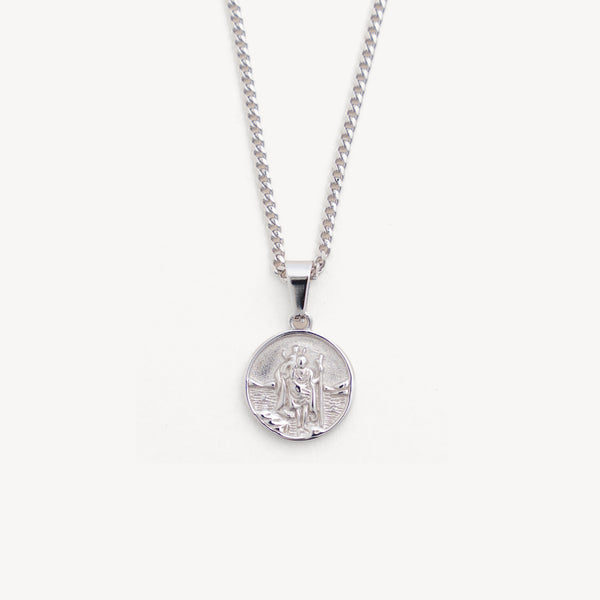 Silver necklace with a round pendant on a white background