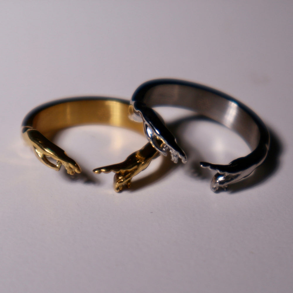 Gold and silver rings on a light gray background