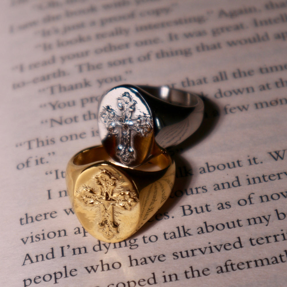 Two rings with cross designs on a book page