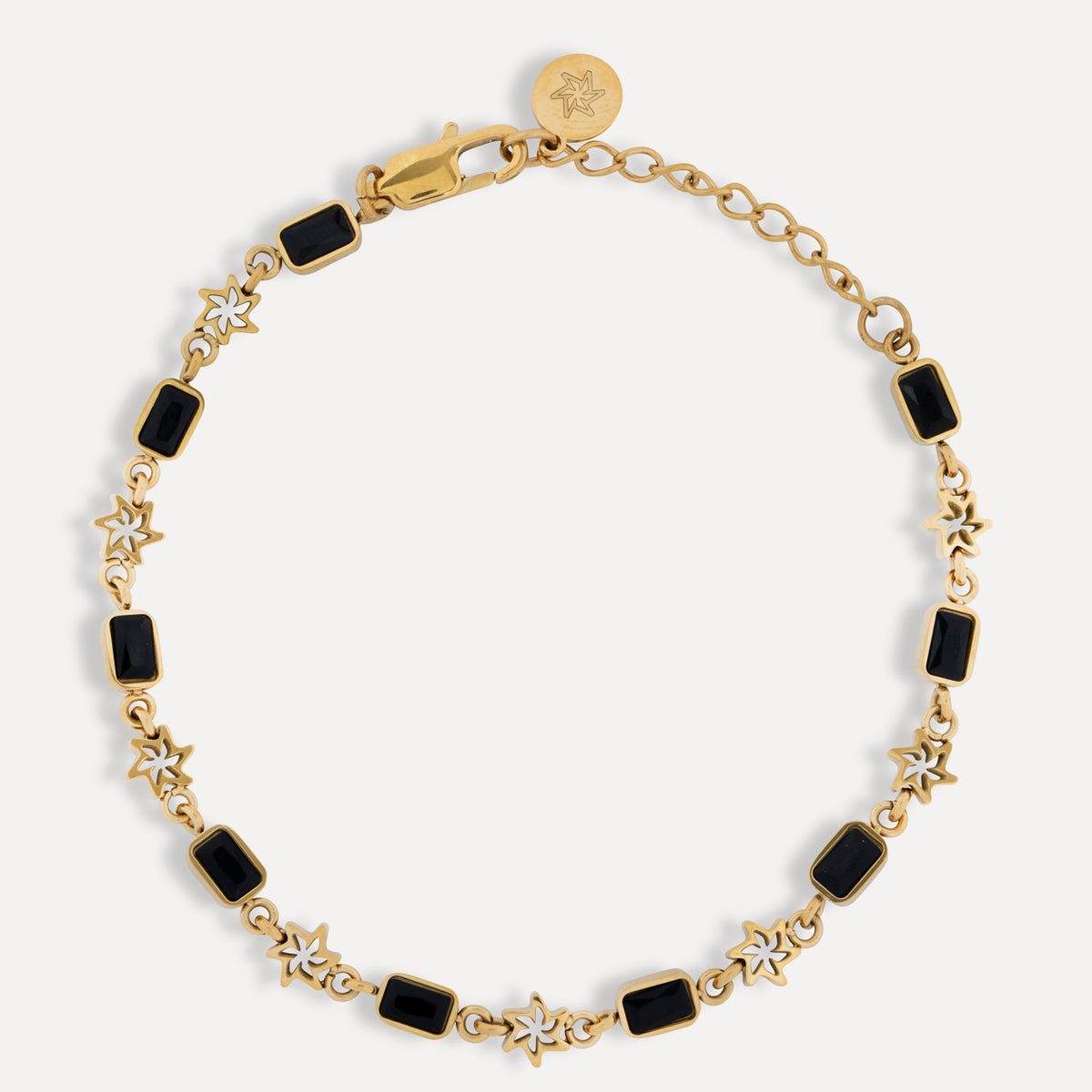 Gold bracelet with black square stones on a white background