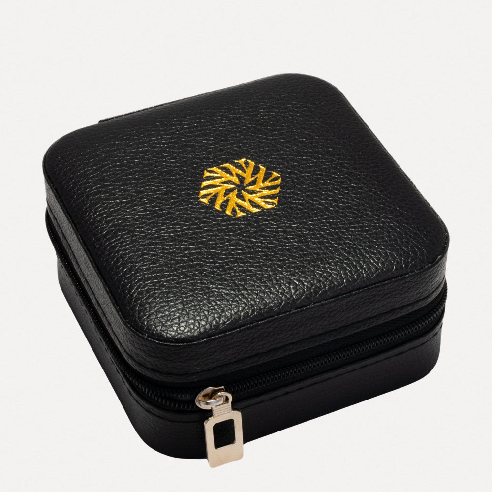 Black leather jewelry case with gold zipper and emblem on a white background