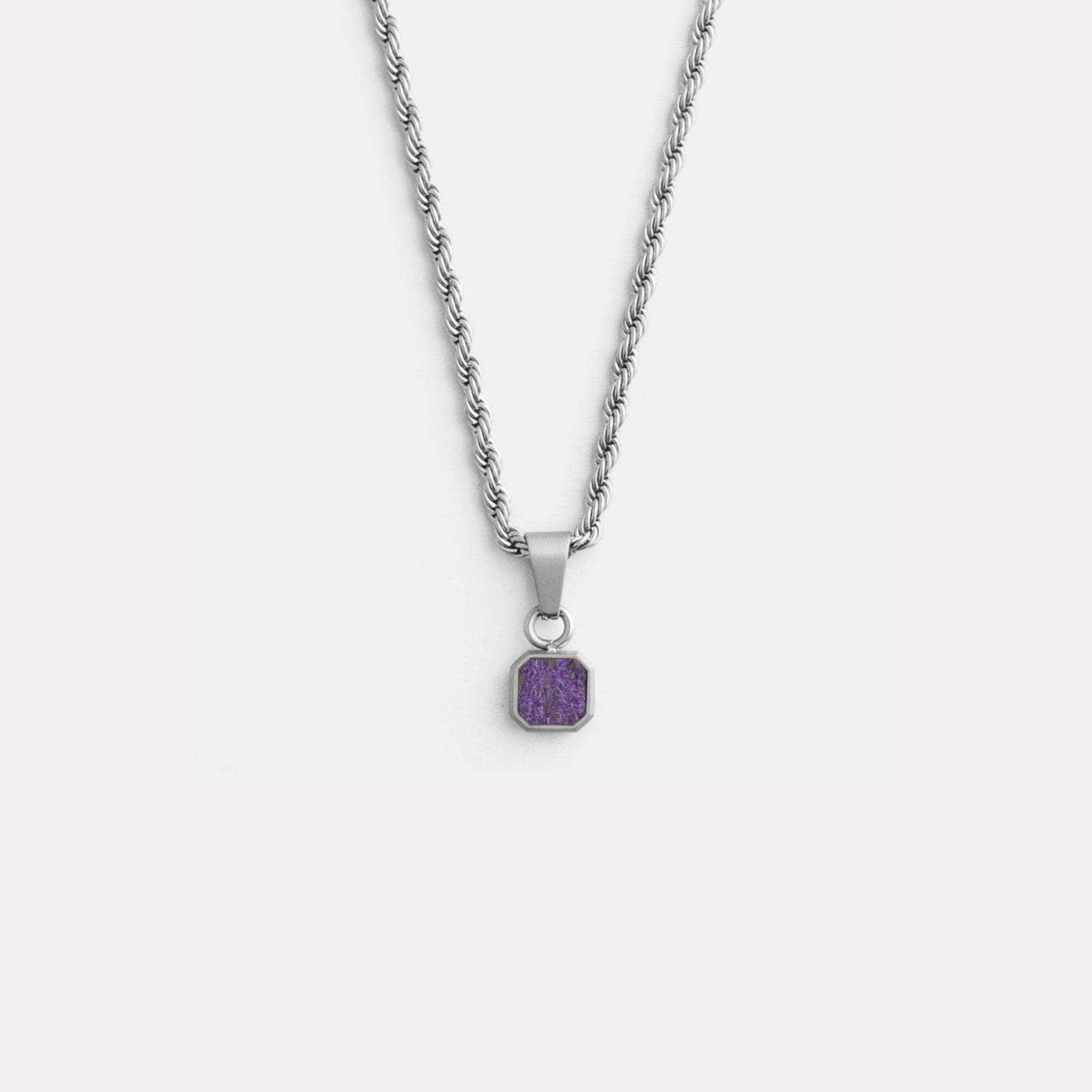 Necklace with a purple pendant on a white background