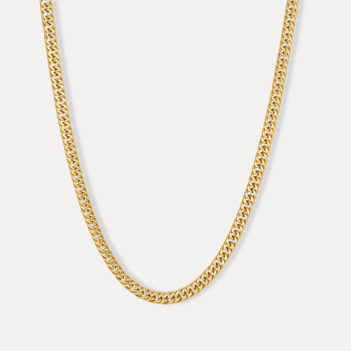 A gold-colored flat Cuban chain necklace with a lobster clasp, displayed against a white background.