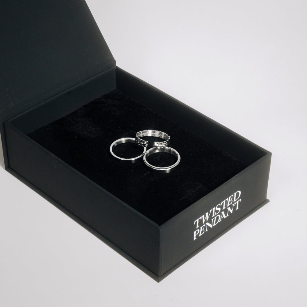 Silver twisted pendant in a black 'Twisted Pendant' box on a light gray background