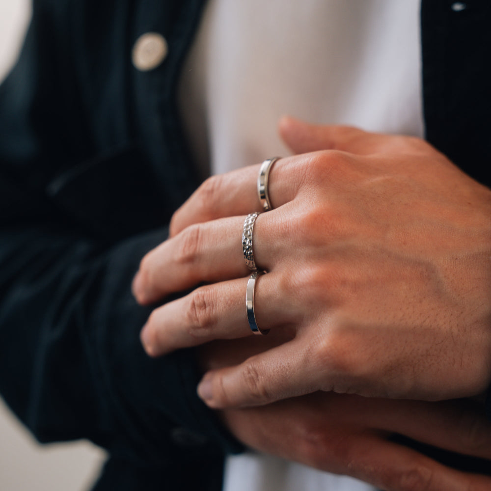 Close-up of hands with silver rings on fingers