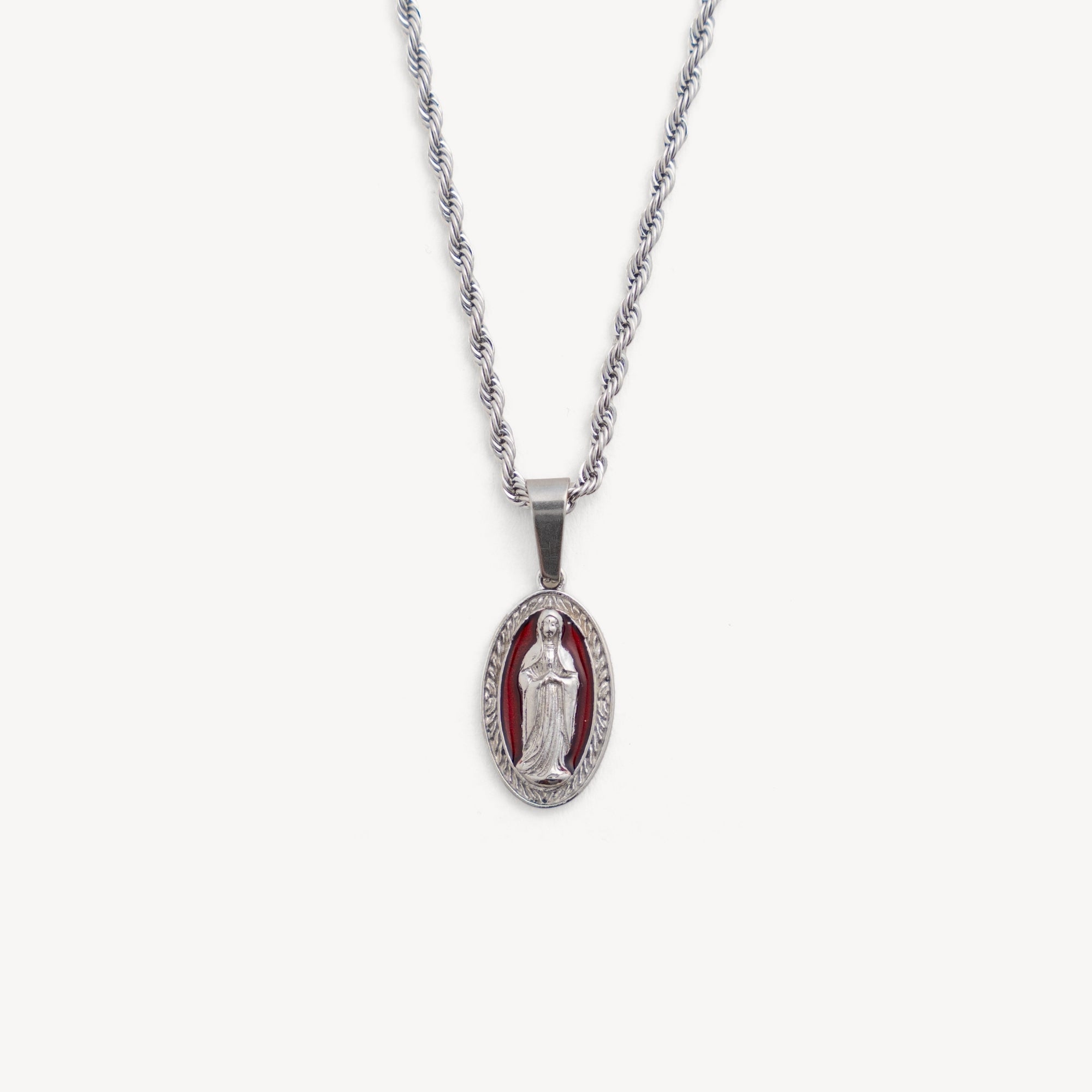 Silver necklace with a pendant featuring a religious figure on a white background