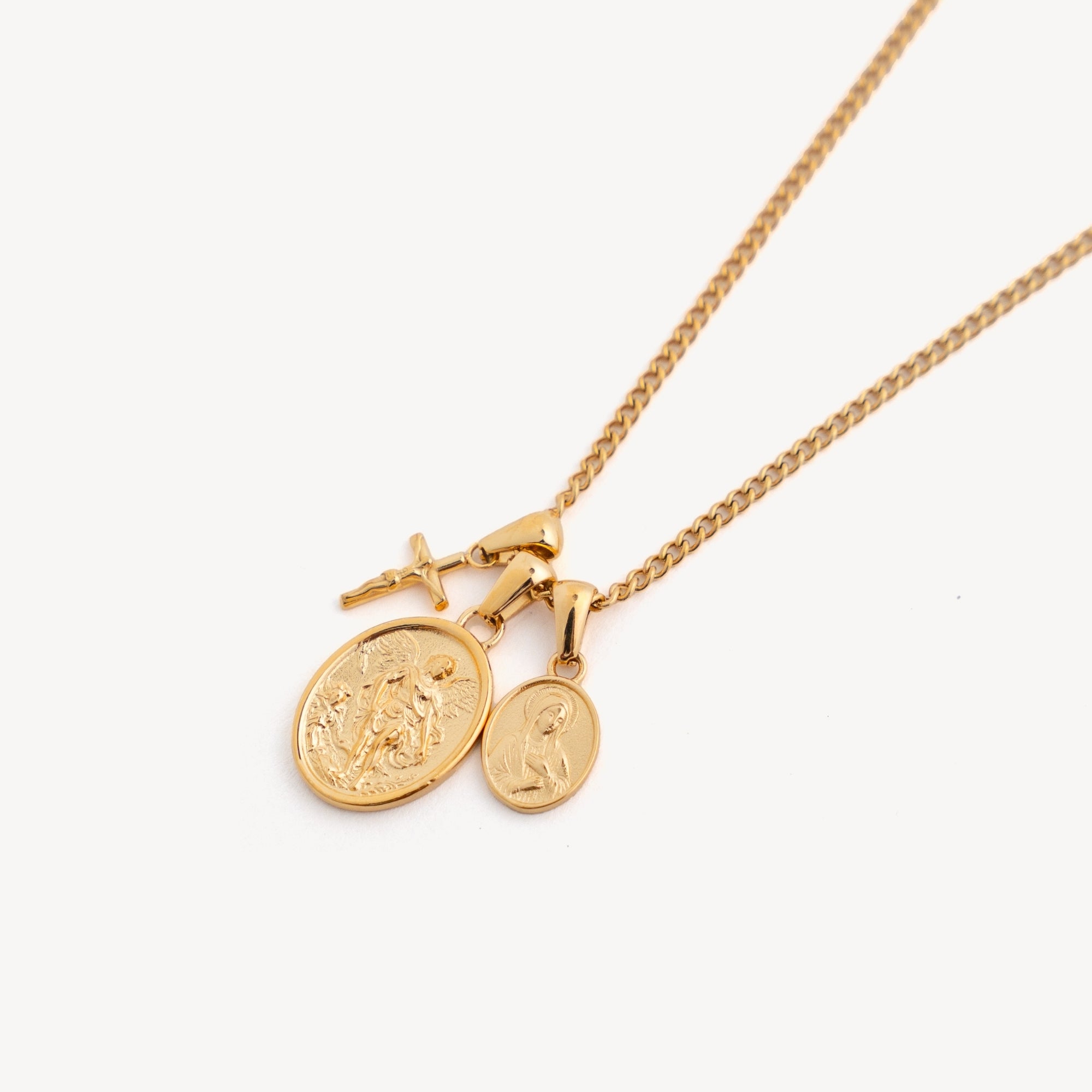 Gold necklace with two round pendants on a white background
