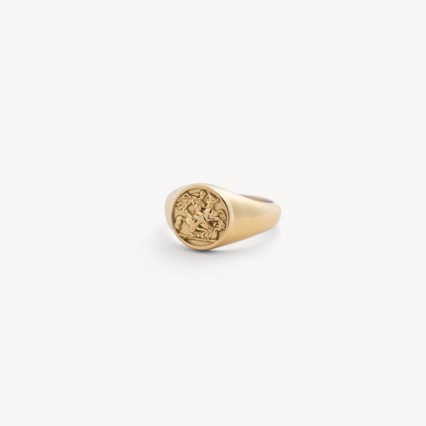 Gold ring with a circular design on a white background