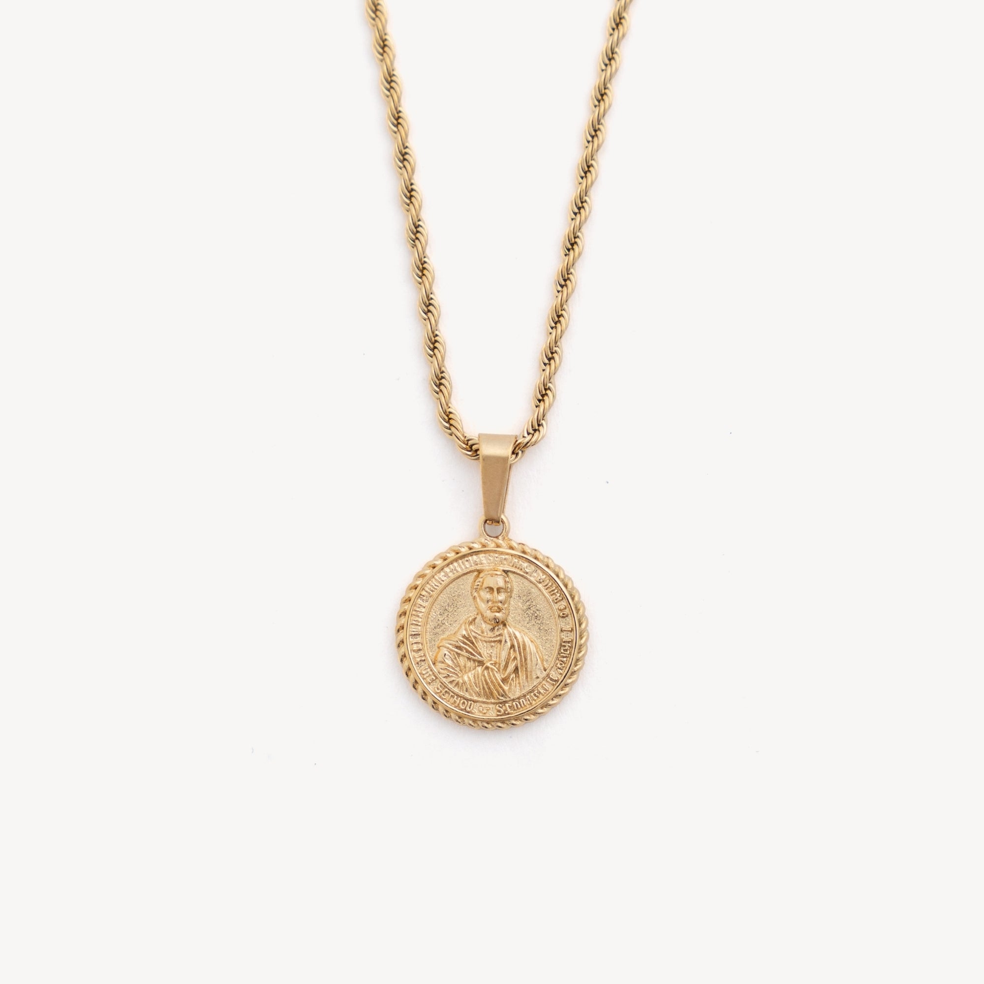Gold necklace with a coin pendant on a white background