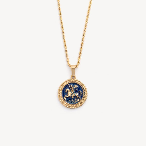 Gold necklace with a blue pendant on a white background