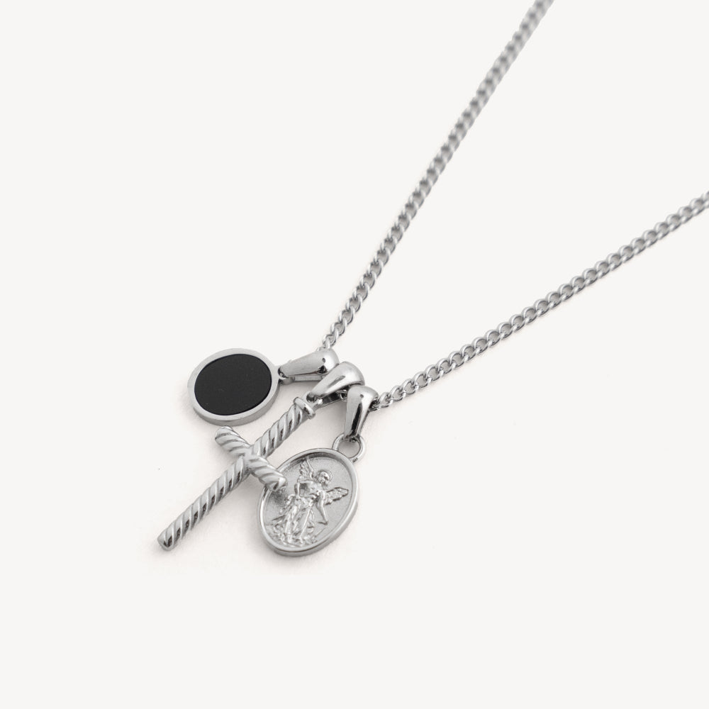 Silver necklace with two pendants on a white background