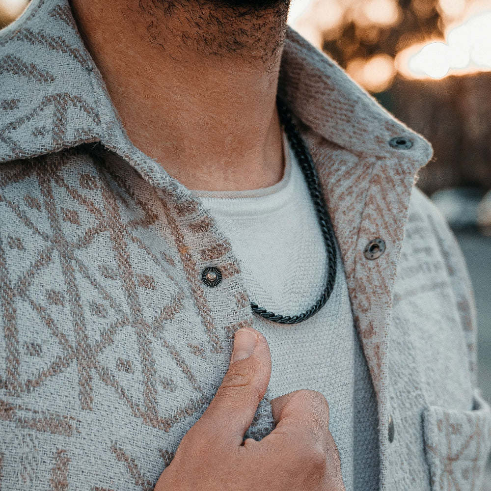 Person wearing a patterned jacket with a blurred background