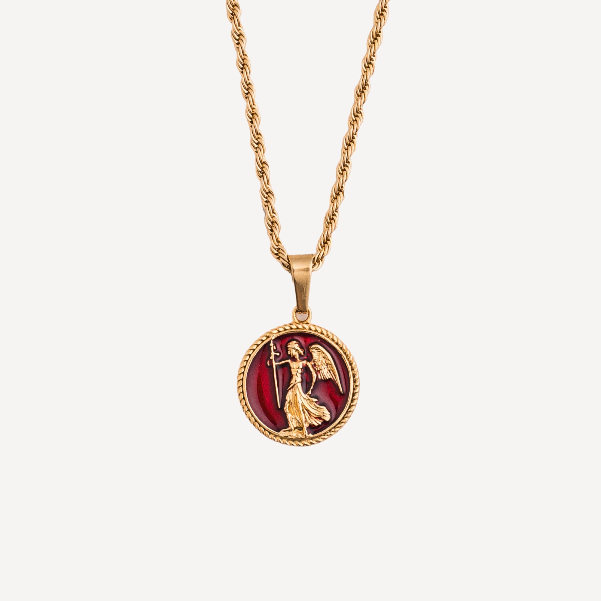 Gold necklace with a red pendant featuring an angelic figure on a white background