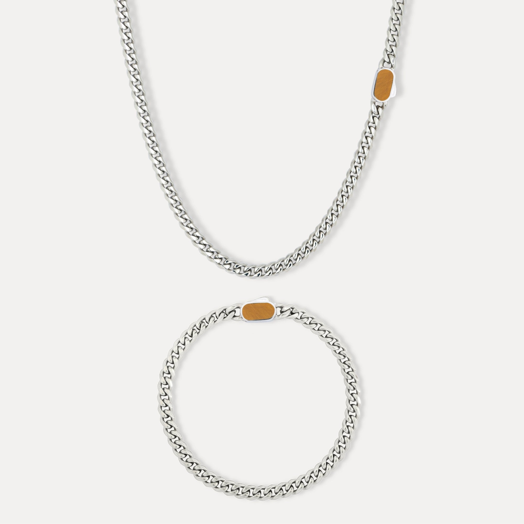 Silver chain necklace with gold accents on a white background